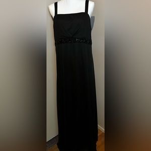 Black sleeveless floor gown with small beaded accents across waist. Size 16